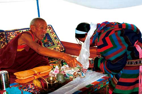 Thupden Rinpoche is bestowing on herders by touching their foreheads.