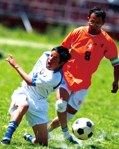 On july 10th,2005,the first football game in the system of seven-footballer games in Lhasa,consisting of 300 footballlers in 24 teams.The photo shows the footballers are struggling for the ball.