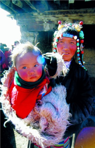Mother and her daughter in religious ceremony of the Chicken Year of the Tibetan calendar.